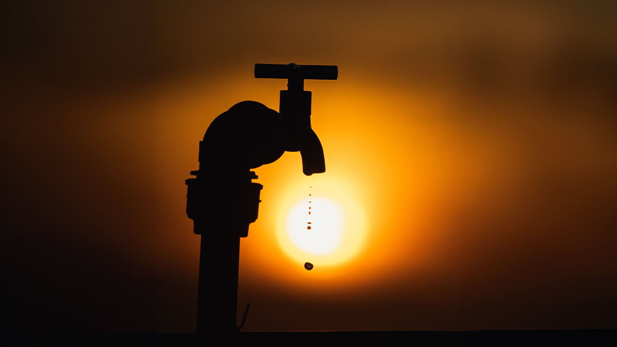 Dripping outdoor faucet representing water outage
